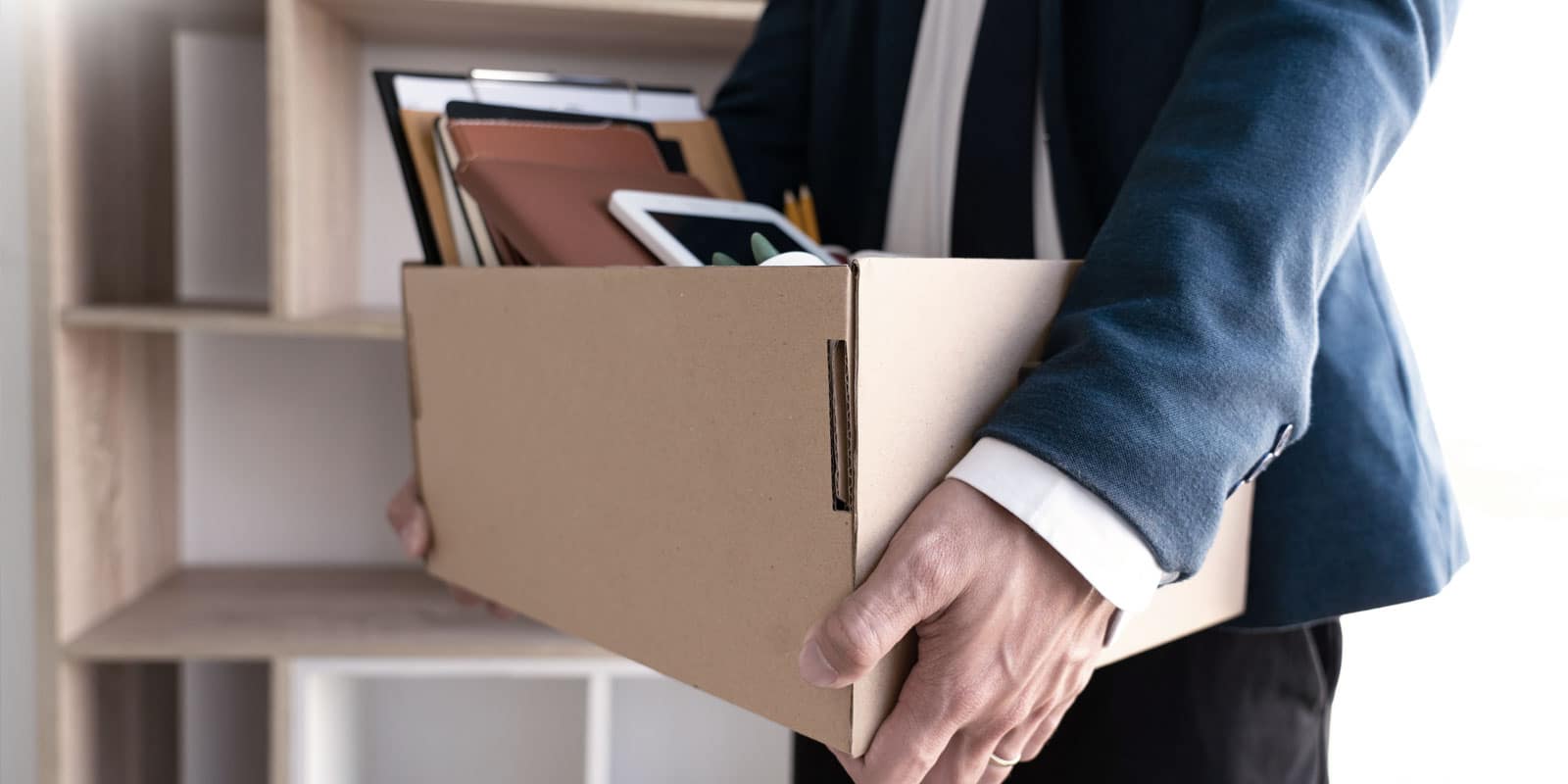 business person carrying a box with their belongings