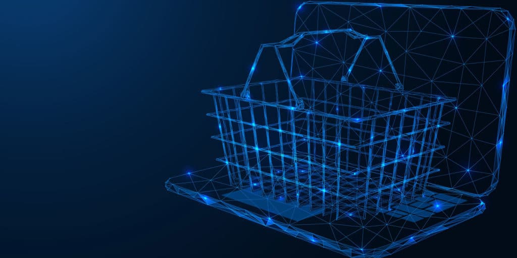 shopping basket on top of laptop represented digitally