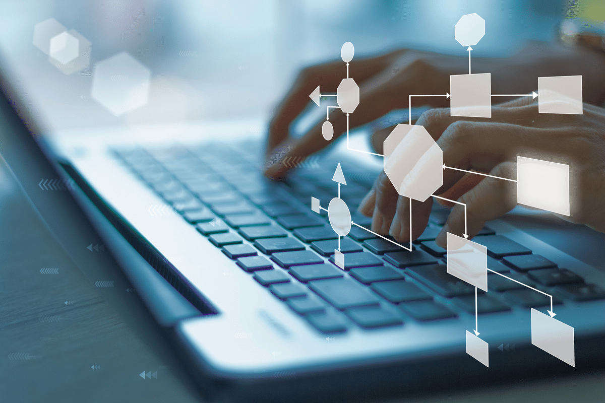 digital flow chart with hands on keyboard of a laptop